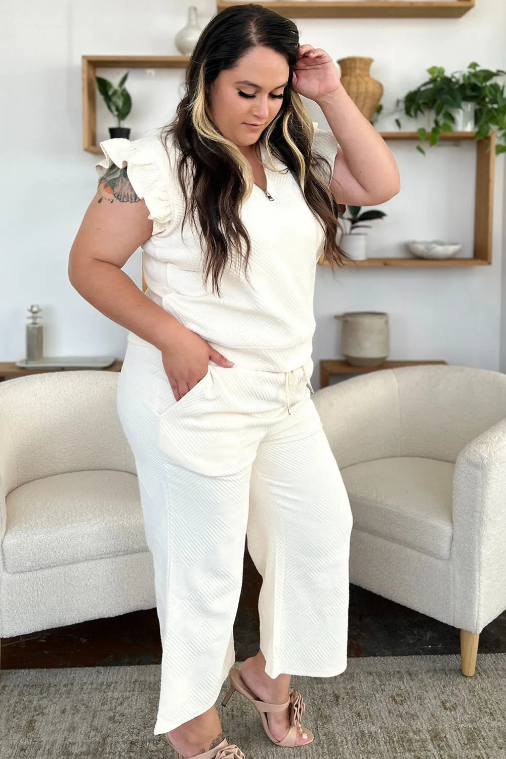 Cream textured ruffle short sleeve top and wide leg pants set on a model.