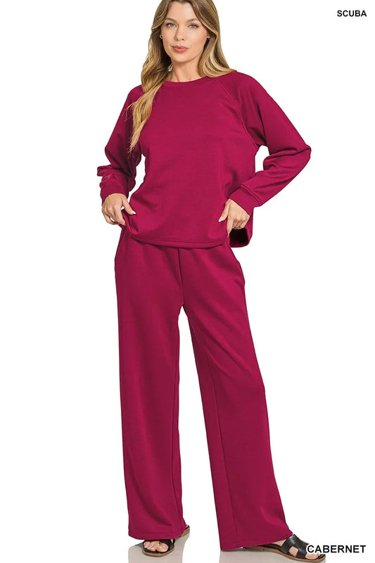 Woman modeling cabernet scuba crewneck sweatshirt and wide-leg pants set.