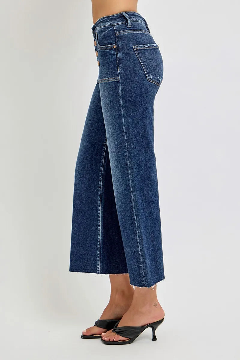 Side view of medium wash high-rise wide-leg crop jeans on a model.