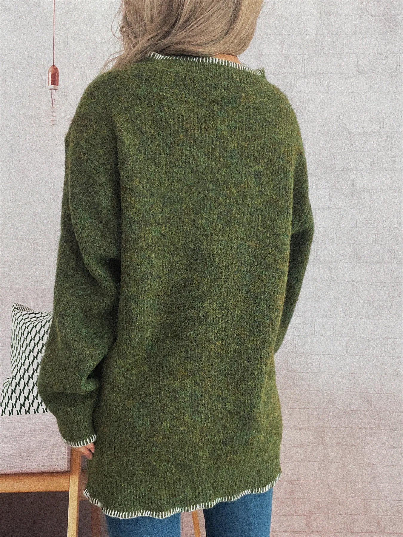 Oversized ribbed sweater with button details and contrast stitching in soft polyester.