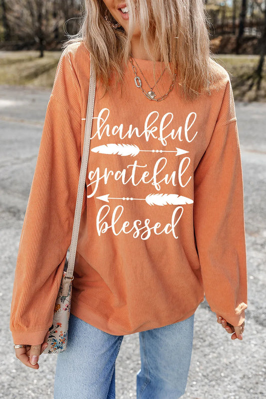 Orange long-sleeve polyester sweatshirt with "Thankful Grateful Blessed" graphic in white letters.