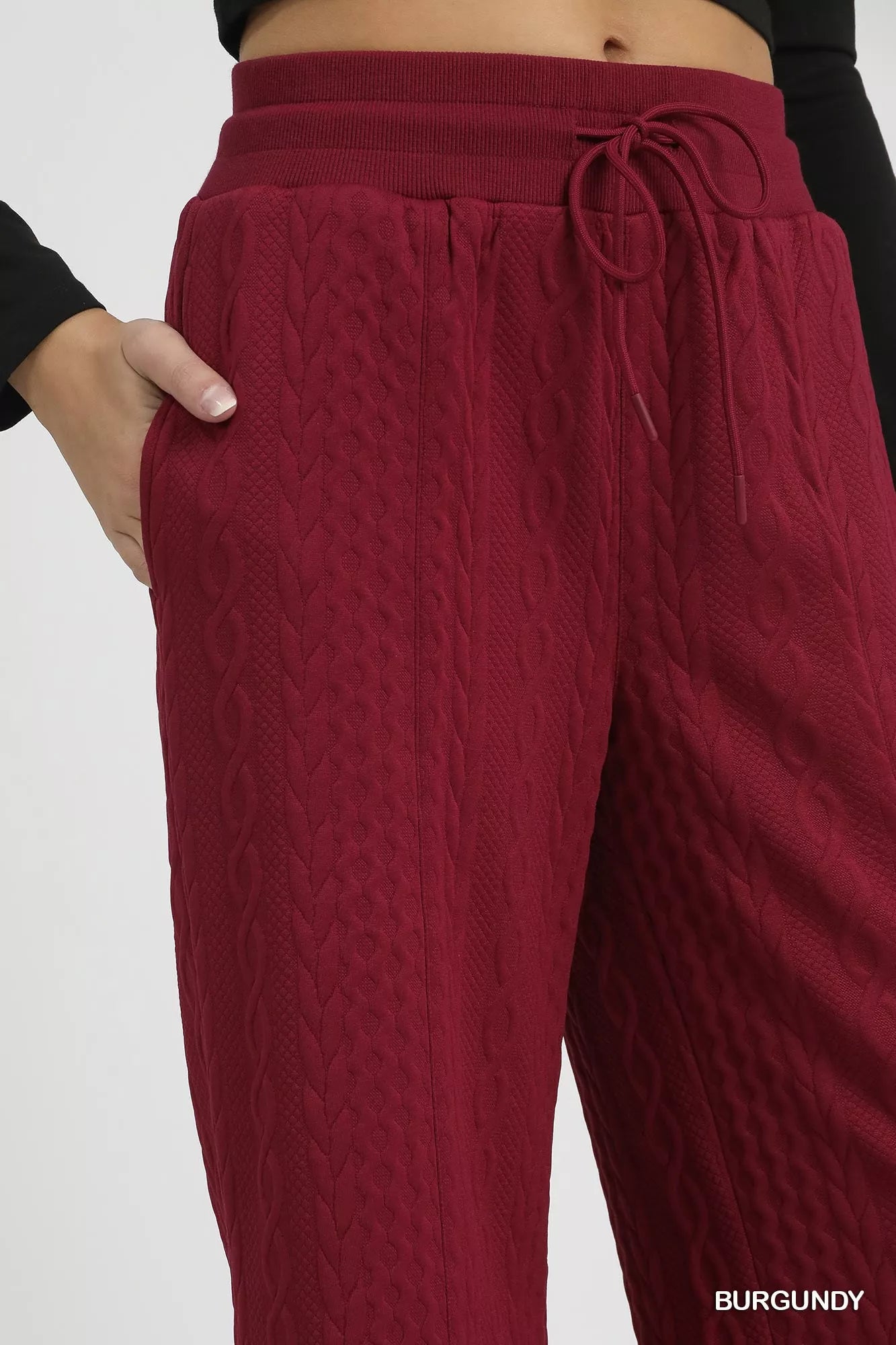 Burgundy cable knit textured wide leg pants with drawstring waist.