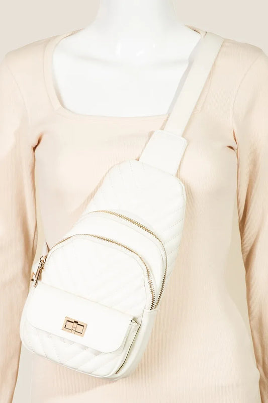 White quilted faux leather sling bag with adjustable strap on mannequin.