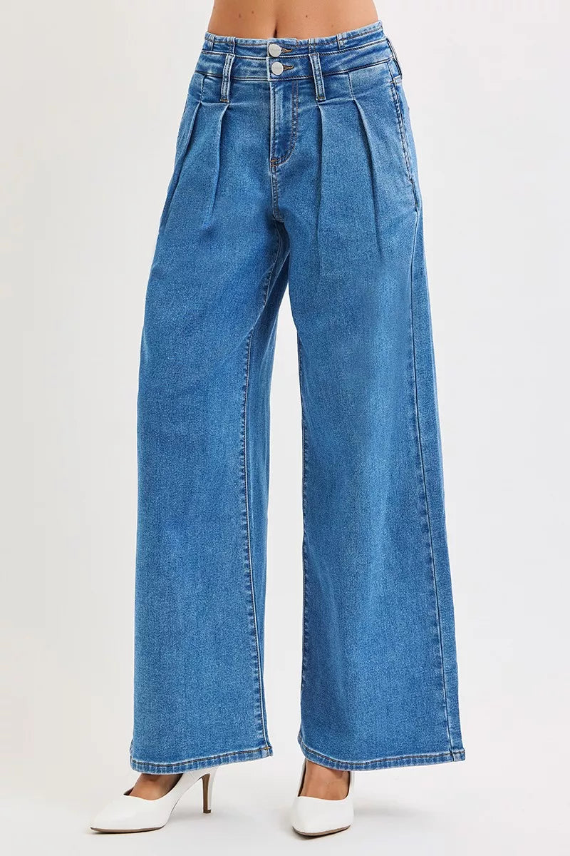 Mid-rise wide-leg pleated jeans in blue denim, plus size, modeled on a figure.