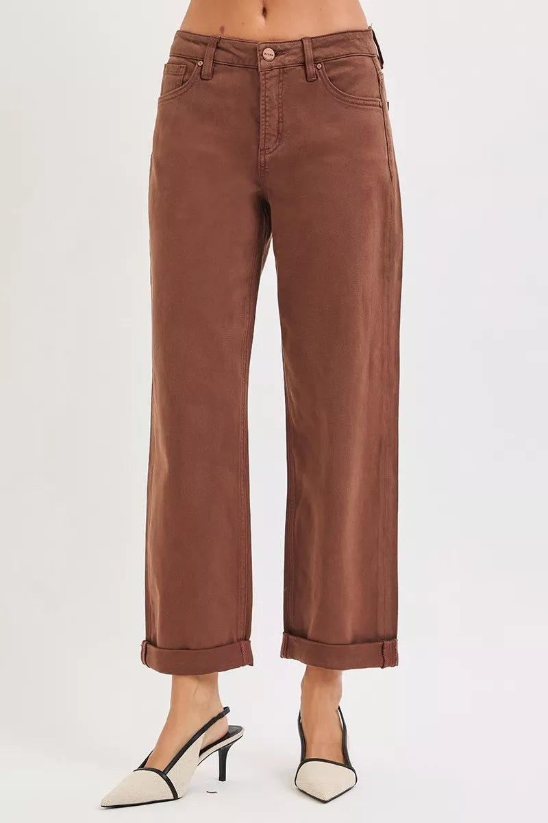 Brown wide-leg high-rise jeans with cuffed hems on a plus-size model.