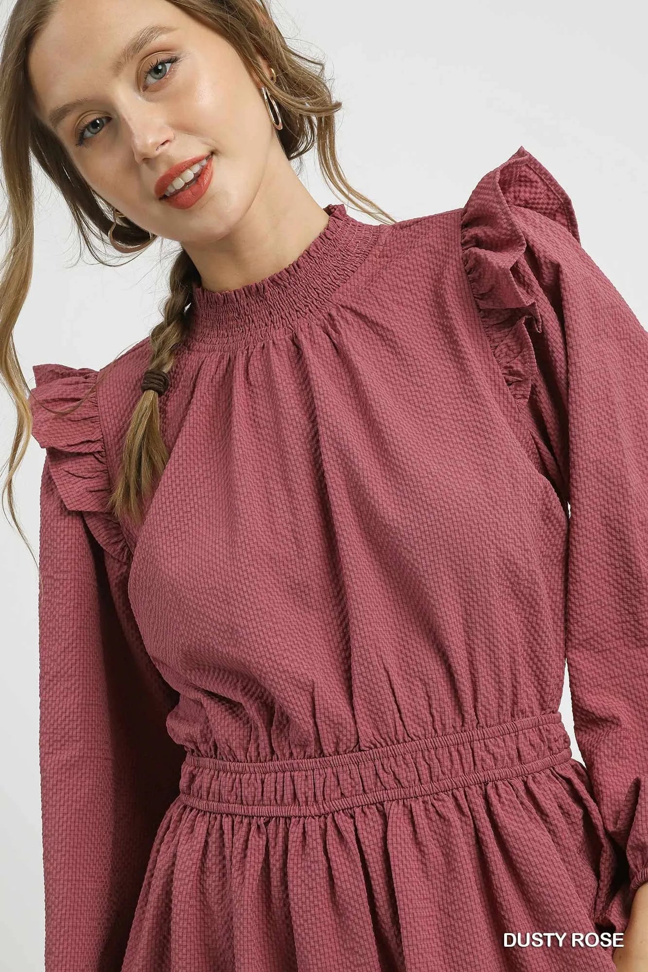 Dusty rose textured midi dress with ruffle shoulders and mock neck.