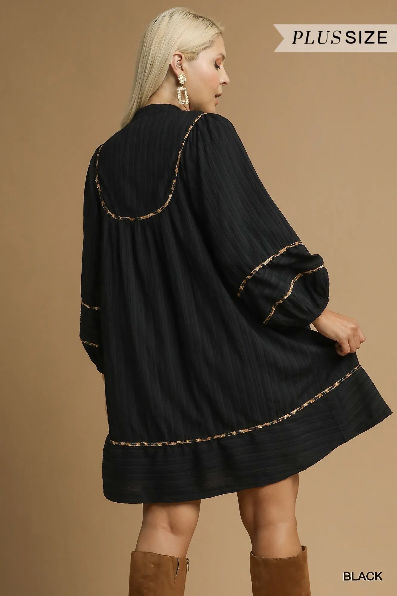 Plus size black textured babydoll dress with leopard trim, shown from back view.