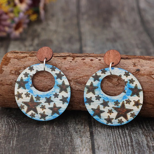 Wooden dangle earrings featuring a cutout star print in alloy and wood materials.