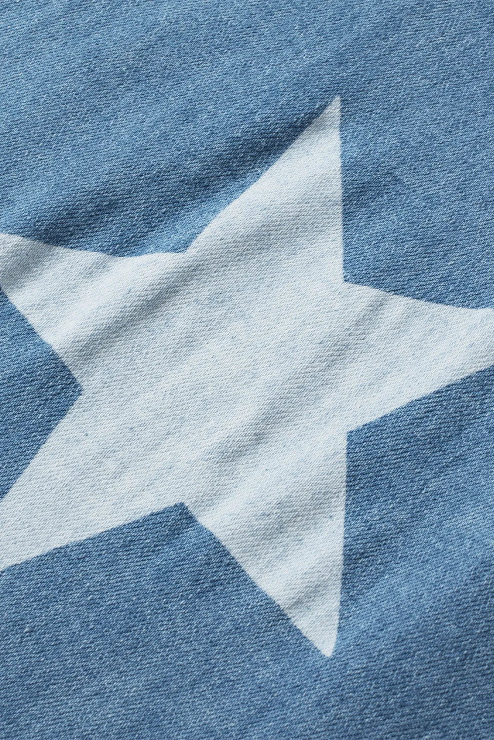 Wide leg denim overalls with star print and pocketed design in a cotton blend fabric.