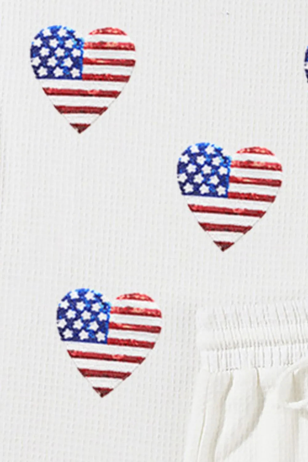 Red, white, and blue sequin top with matching shorts in a coastal style two-piece set.