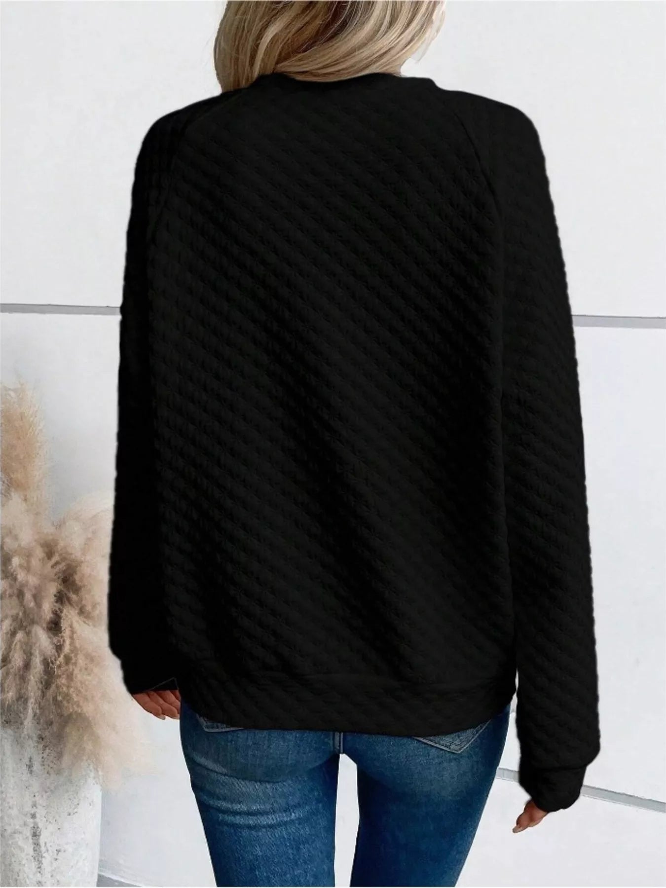 Textured notched raglan sleeve sweatshirt in a basic style with a relaxed fit.