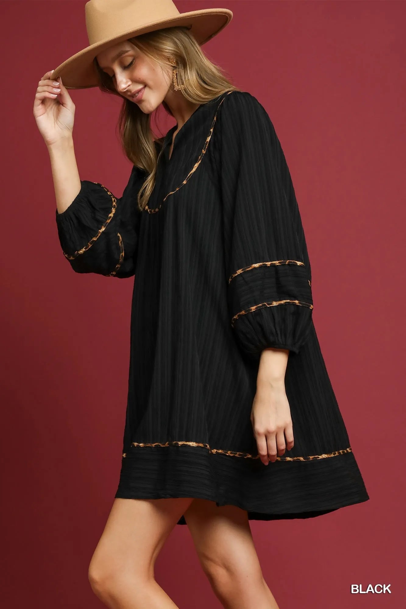 Plus-size textured babydoll dress in black with leopard trim and puffed sleeves.