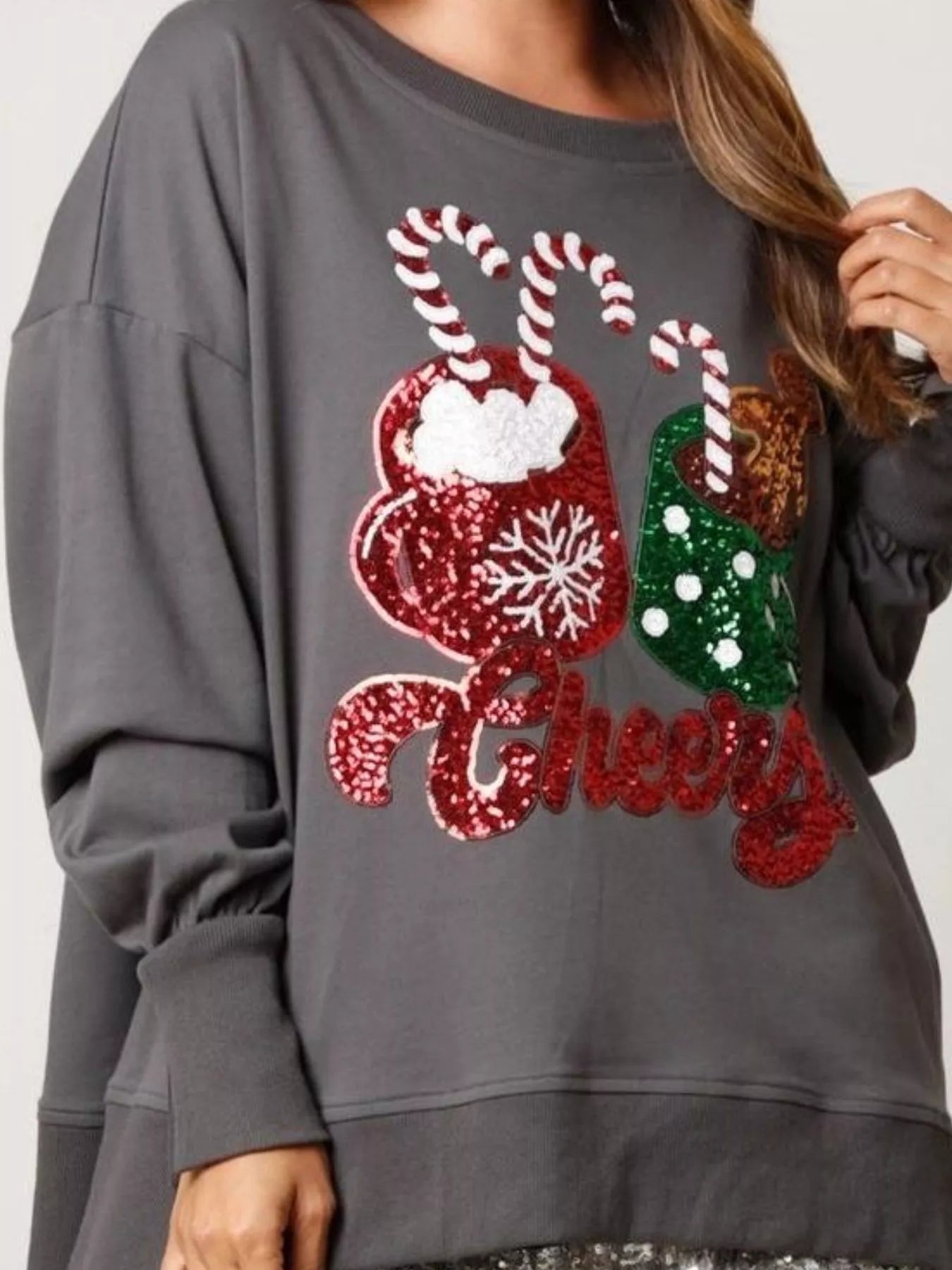 High-low sweatshirt with sequins in festive design made of polyester fabric