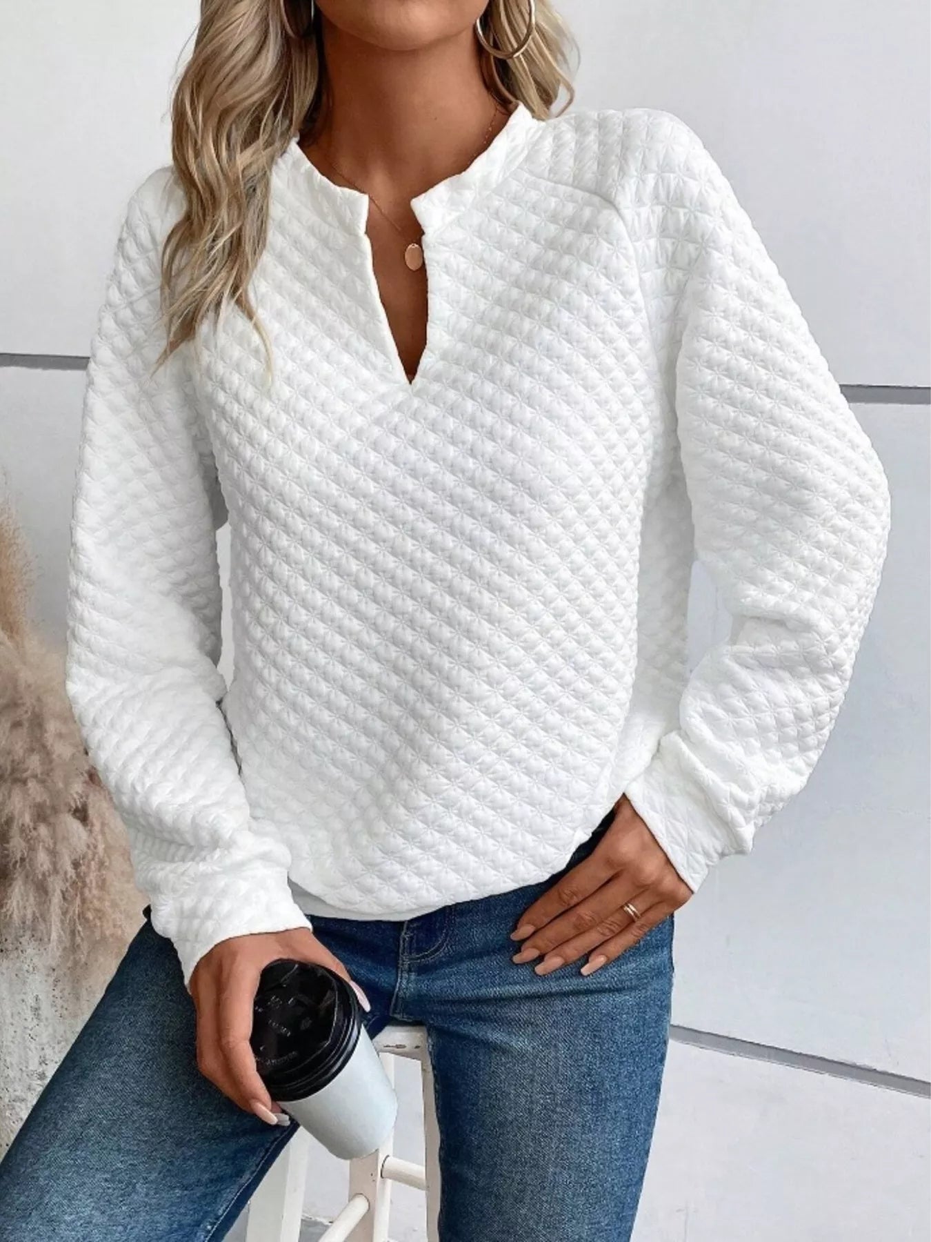 Gray textured sweatshirt with notched raglan sleeves and a relaxed fit.